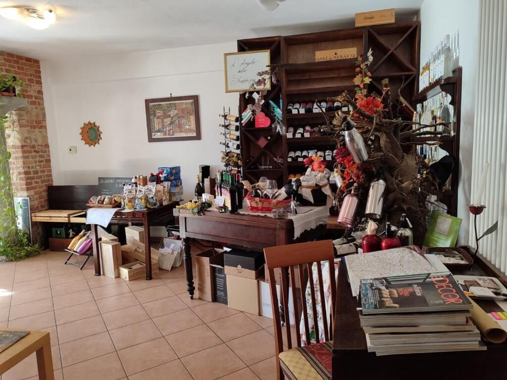 A cluttered room with a variety of items including books, bottles, and decorative objects.