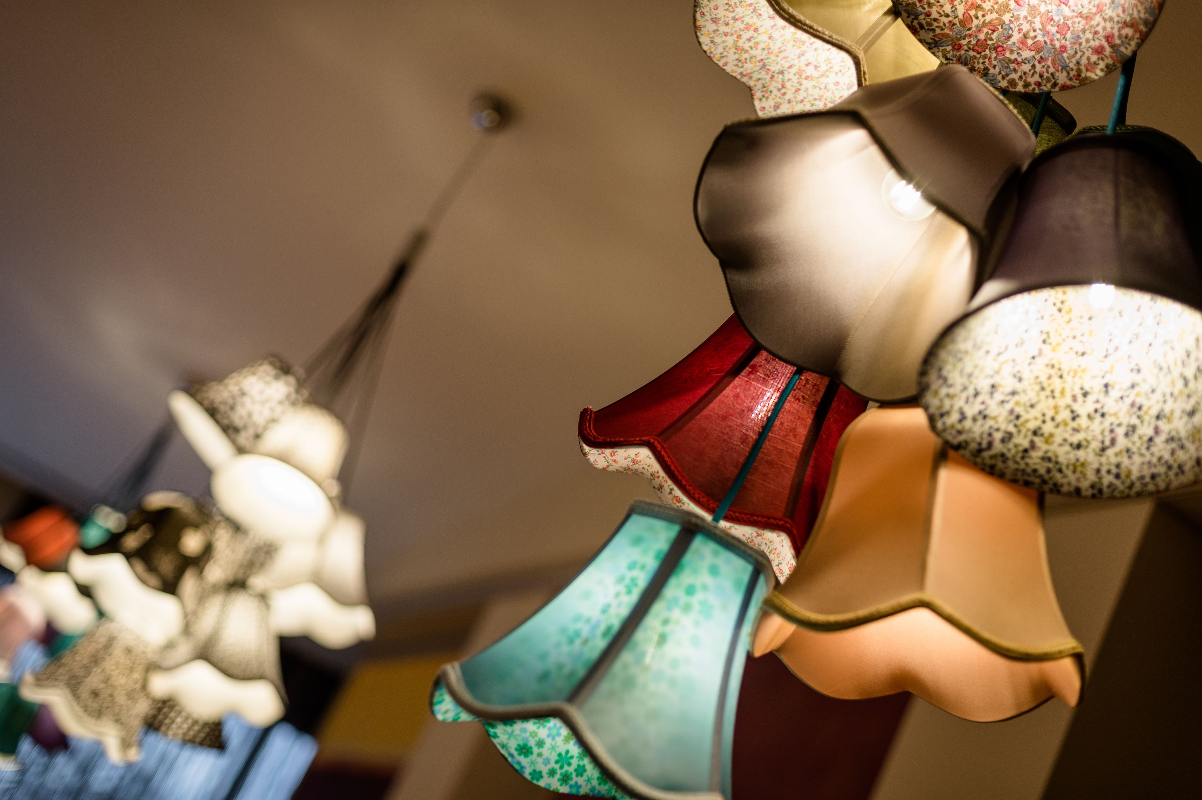 A variety of hanging lamps with different shapes and patterns.