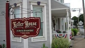 A building with a sign that reads "Keller House A Bed & Breakfast" and a phone number. - Keller House (Centre Hall)