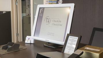 A check-in/check-out kiosk at Hotel Finn with instructions on the screen.
