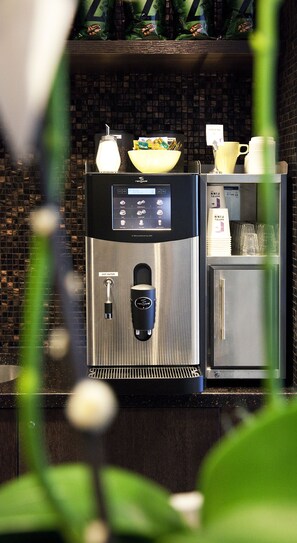A water dispenser with a hot water tap, a coffee machine, and a refrigerator. - Finn Apartments (Lund)