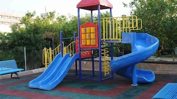 Children can play on the tower with a slide and stairs in this outdoor play area.