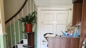 A staircase with a potted plant, a wooden door labeled "PRIVATE," and a carpeted floor with a patterned rug. - Blossom Guest House (Edinburgh)