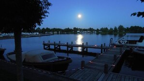 A dock with boats and a calm water body at dusk.