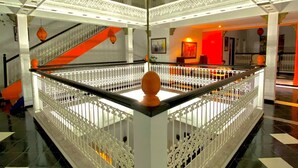 A spacious atrium with a central open area, white railings, and a decorative ceiling. - Riad Baddi (Salé)