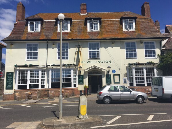 A traditional building with a sign reading "The Wellington" on the facade. - Wellington Hotel (Seaford)