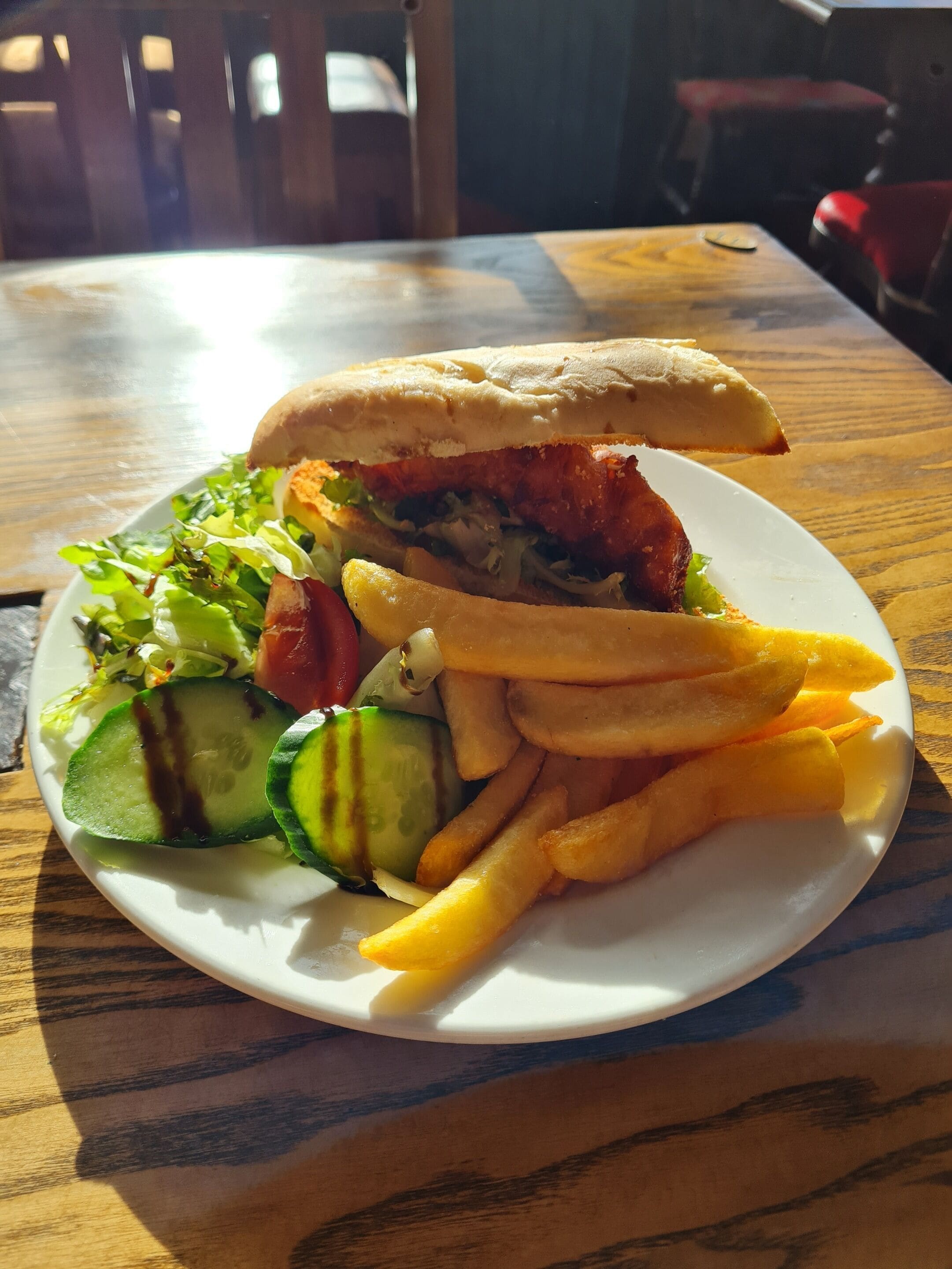 A plate with a sandwich, fries, and a salad.