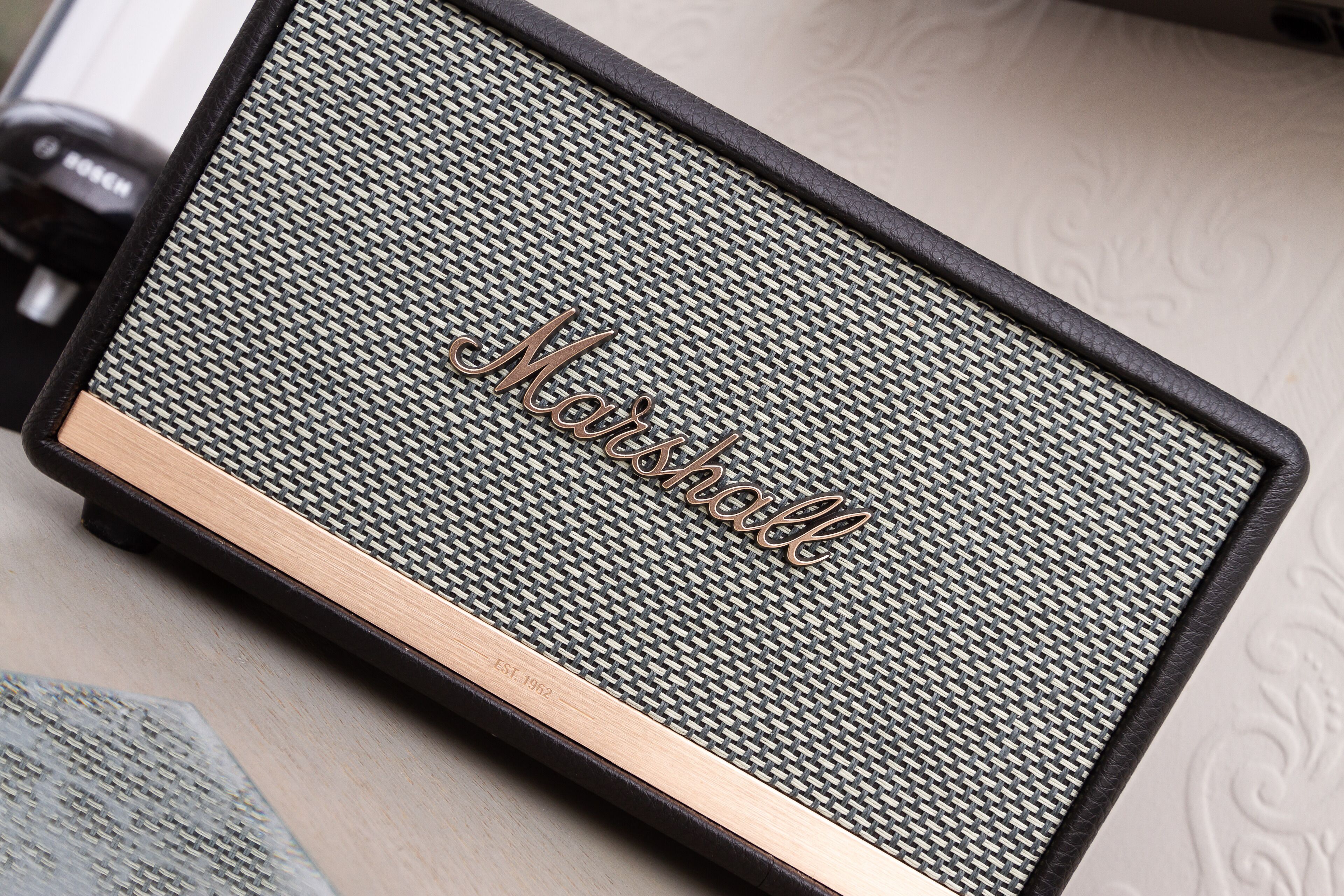 A close-up of a speaker with the brand name "Marshall" visible on the grille.