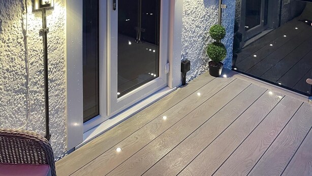 A house with a white exterior, a glass door, and a balcony with a railing. - Glencree (Windermere)