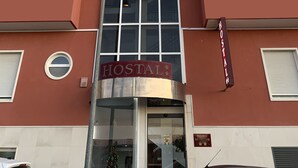 A building with a sign reading "HOSTAL MESFQUIER" and "HOSTAL" indicating it is a hostel. - Hostal Meseguer (Elche)