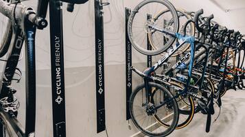 A bike rack with multiple bicycles secured to it.