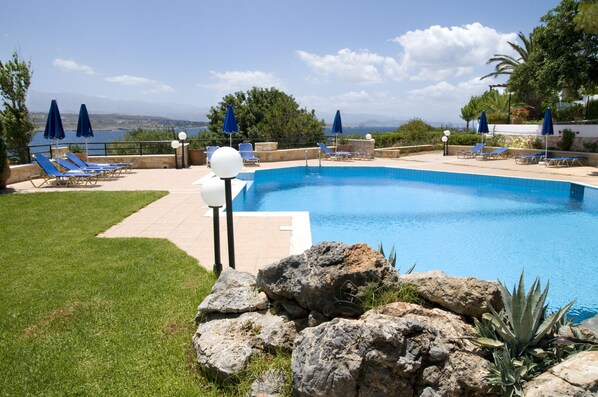 Seasonal outdoor pool, pool umbrellas, pool loungers