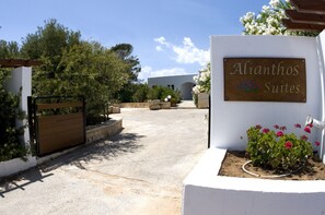 A gated entrance with a sign for 'Alianthos Suites' and a pathway leading to a building. - Alianthos Suites (Chania)