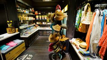 A store interior with shelves of various products, a display of hats, and a counter with items for sale.