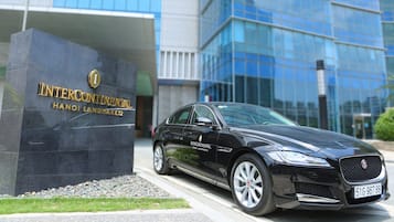 A black Intercontinental hotel car parked in front of the building.