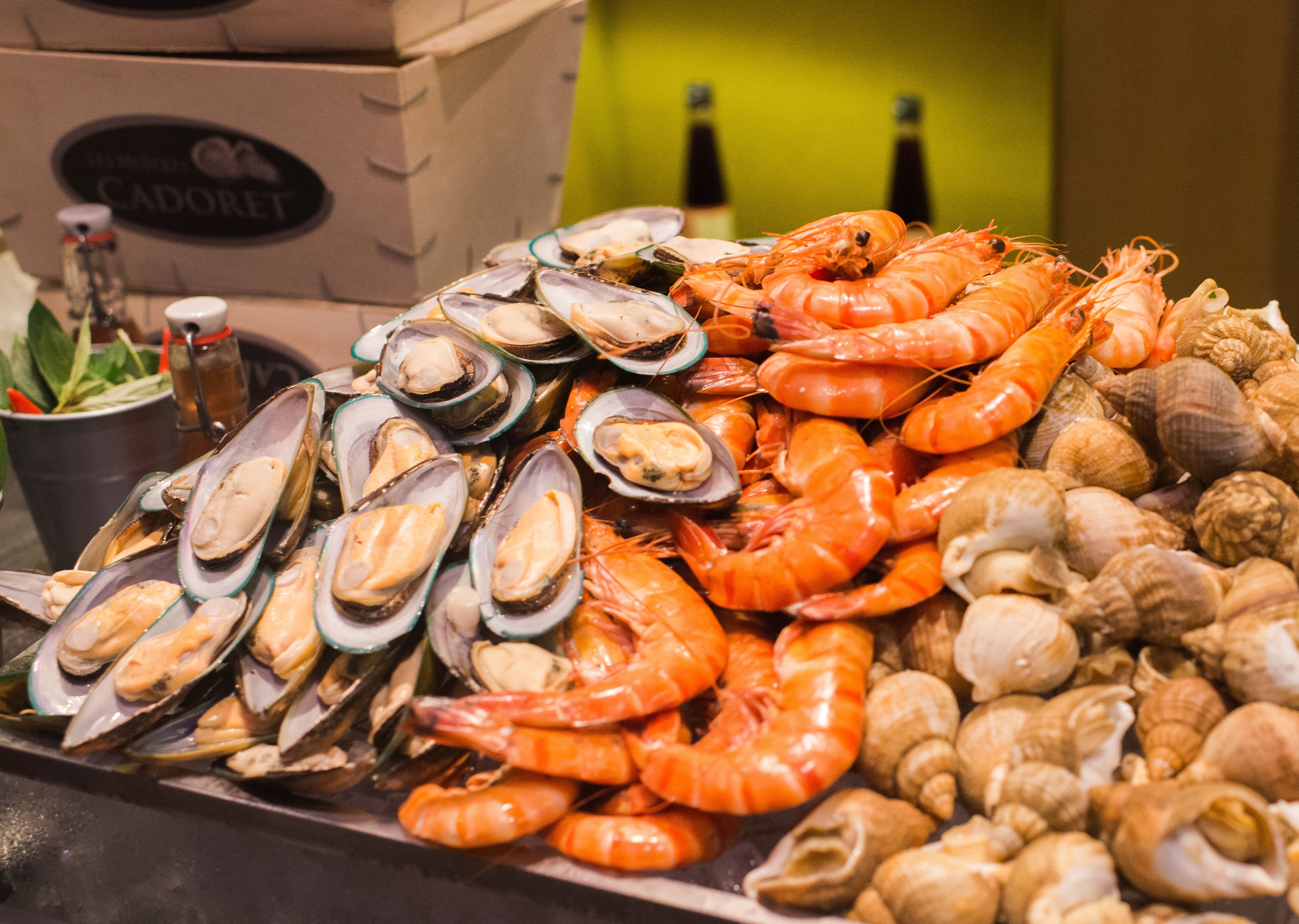 A seafood display with mussels, shrimp, and shells.
