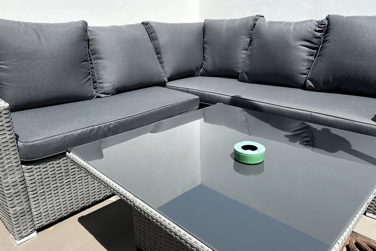 A sectional sofa with a glass-top coffee table.