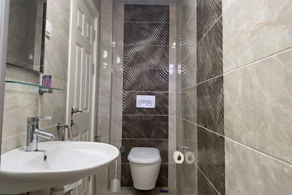 Shower, hair dryer, slippers, towels