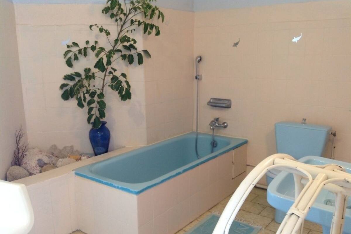 A bathroom with a bathtub, toilet, and shower.