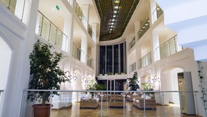 A spacious atrium with high ceilings, multiple balconies, and a central staircase. - Hotel Vita Bella Resort & Spa (Bodrum)