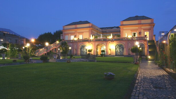A large, multi-story building with a well-maintained lawn and a cobblestone pathway leading to the entrance. - Villa Signorini Events & Hotel (Ercolano)