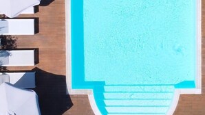An aerial view of a rectangular swimming pool with a white edge, surrounded by white umbrellas and lounge chairs. - Villa Signorini Events & Hotel (Ercolano)