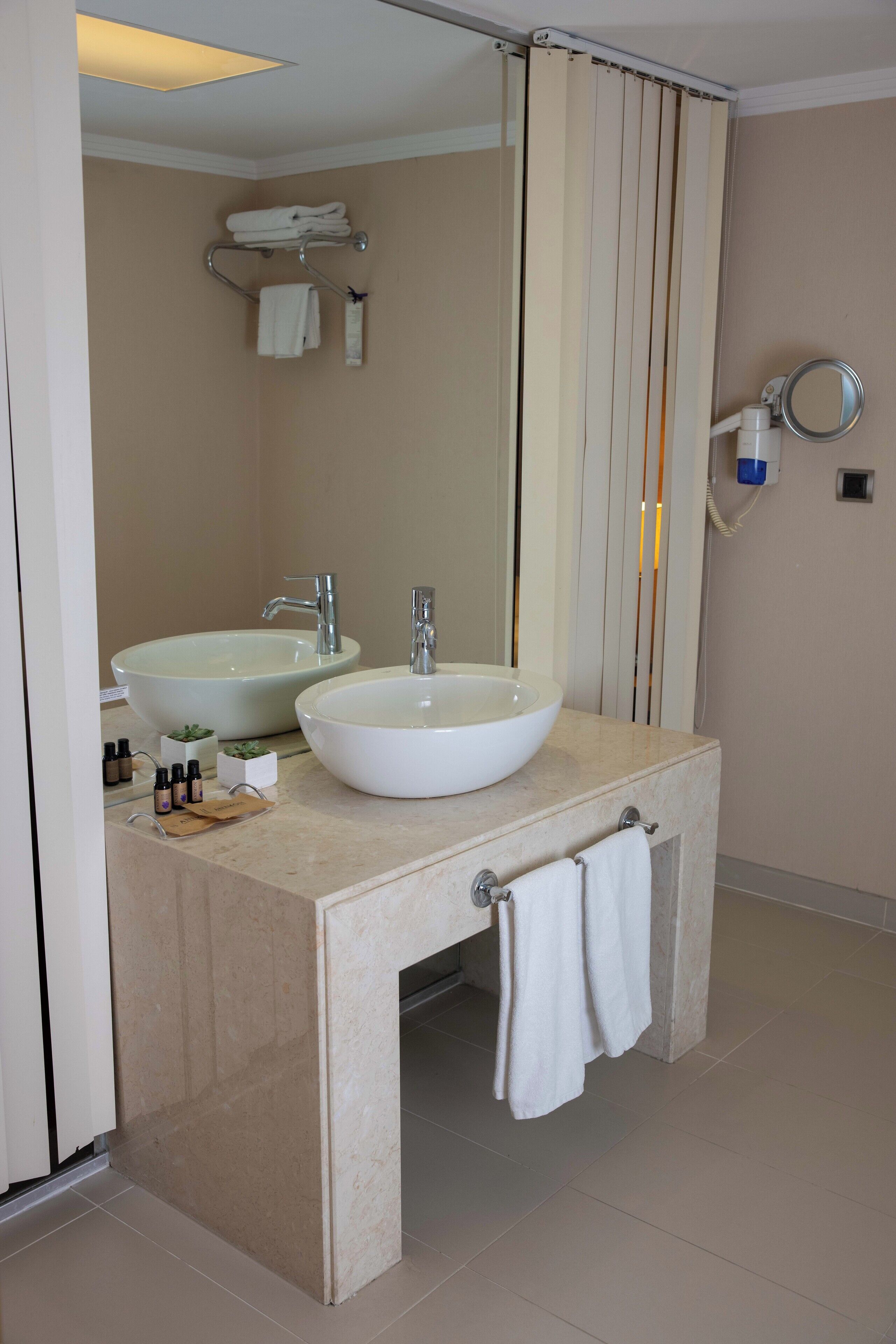 deluxe room | bathroom | shower, rainfall showerhead, hair dryer, slippers