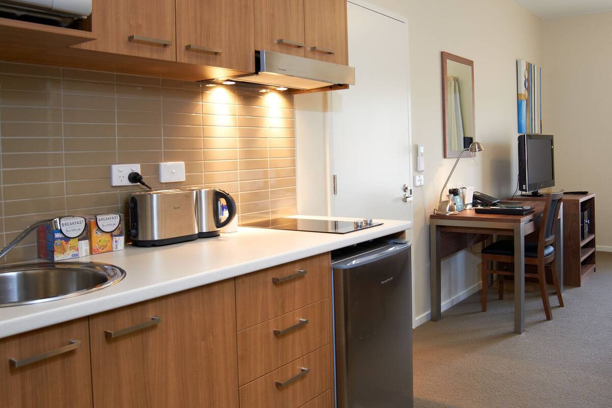 full-sized fridge, microwave, stovetop, coffee/tea maker