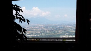 A view from a window overlooking a cityscape with mountains in the distance. - Grande Albergo Abruzzo (Chieti)
