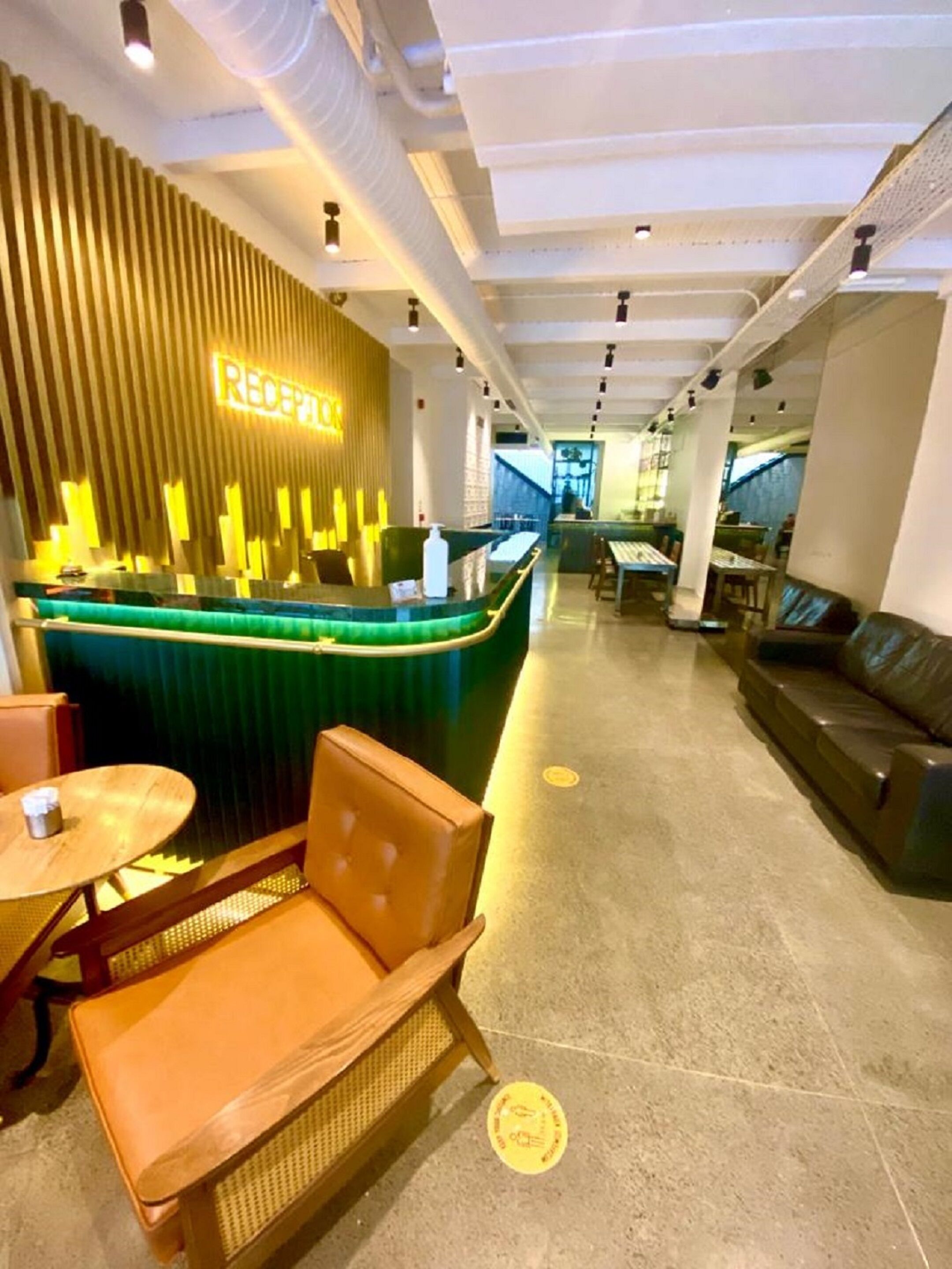 A reception area with a counter, seating, and a view of the interior.