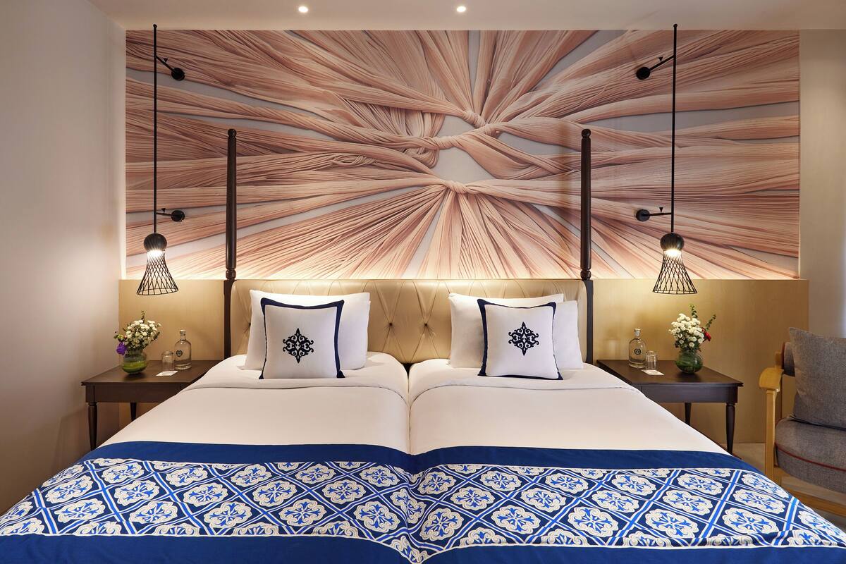 premium room, 2 single beds, balcony, pool view | pillow-top beds, minibar, in-room safe, individually decorated