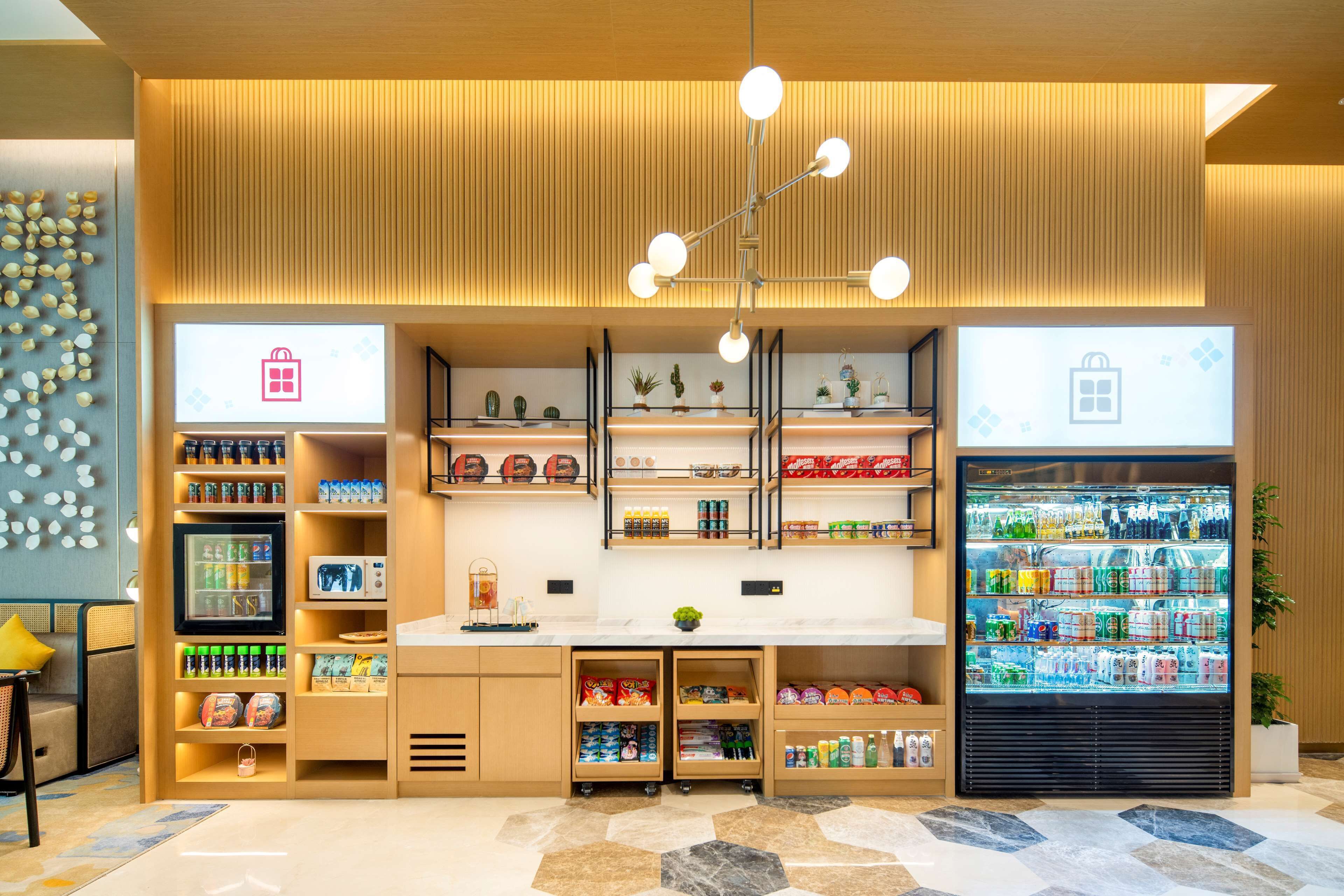 A modern retail space with a variety of products, including snacks and beverages, and a refrigerated display case.
