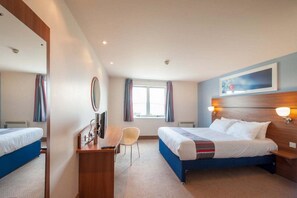 A hotel room with two beds, a desk, a chair, a large mirror, and a window with curtains. - Travelodge Derby Pride Park (Derby)