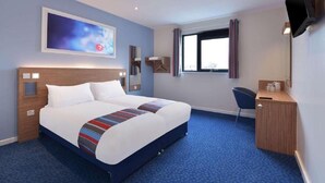 A hotel room with a large bed, a desk, a chair, a flat-screen TV mounted on the wall, and a window with curtains. - Travelodge Derby Pride Park (Derby)