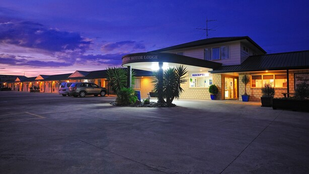 Un motel con un cartello che riporta "Crock Motor Lodge" e un'area reception.