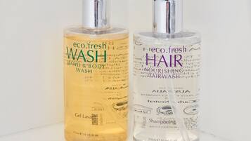 Two bottles of eco.fresh hair and body wash on a white surface.
