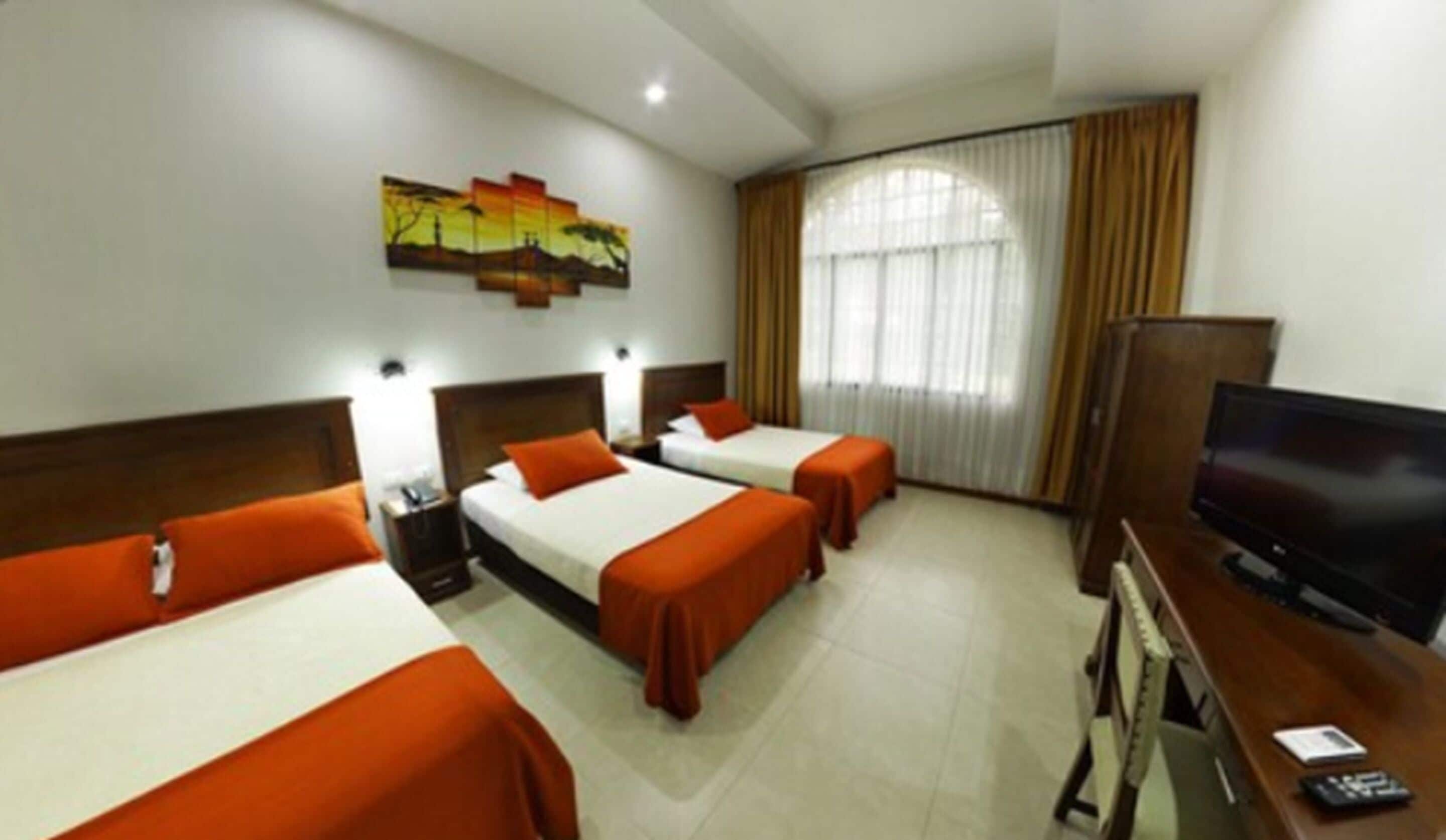 standard triple room, multiple beds | minibar, in-room safe, individually furnished, desk
