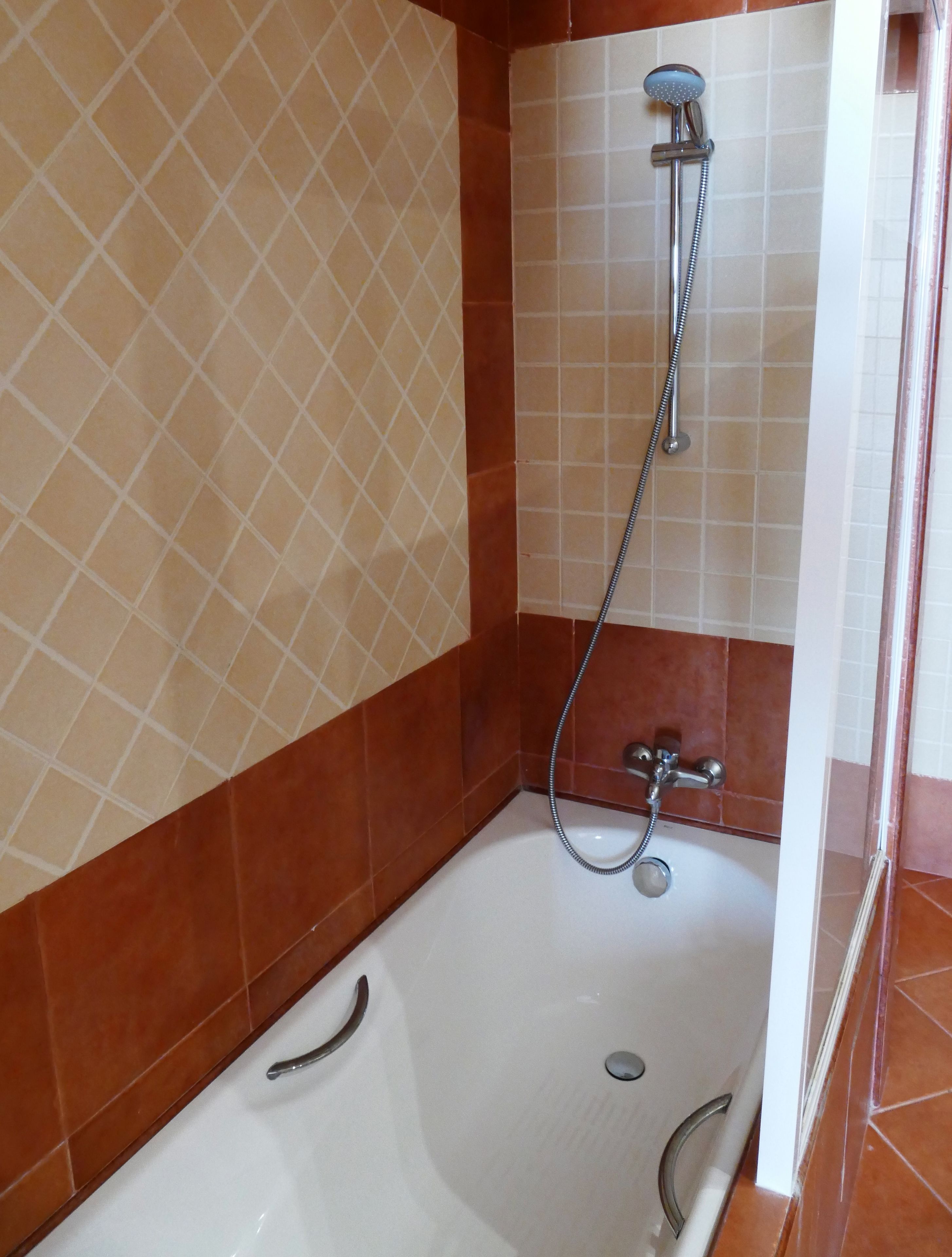 A bathroom with a bathtub, a shower, and a toilet.