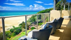 A balcony with outdoor seating and a view of the beach and ocean. - The Beach Cabarita (Cabarita Beach)