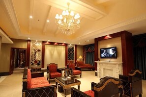A hotel room with a fireplace, television, and seating area. - Silver Lake Island Hotel At Lugu Lake, Yunnan (Lijiang)