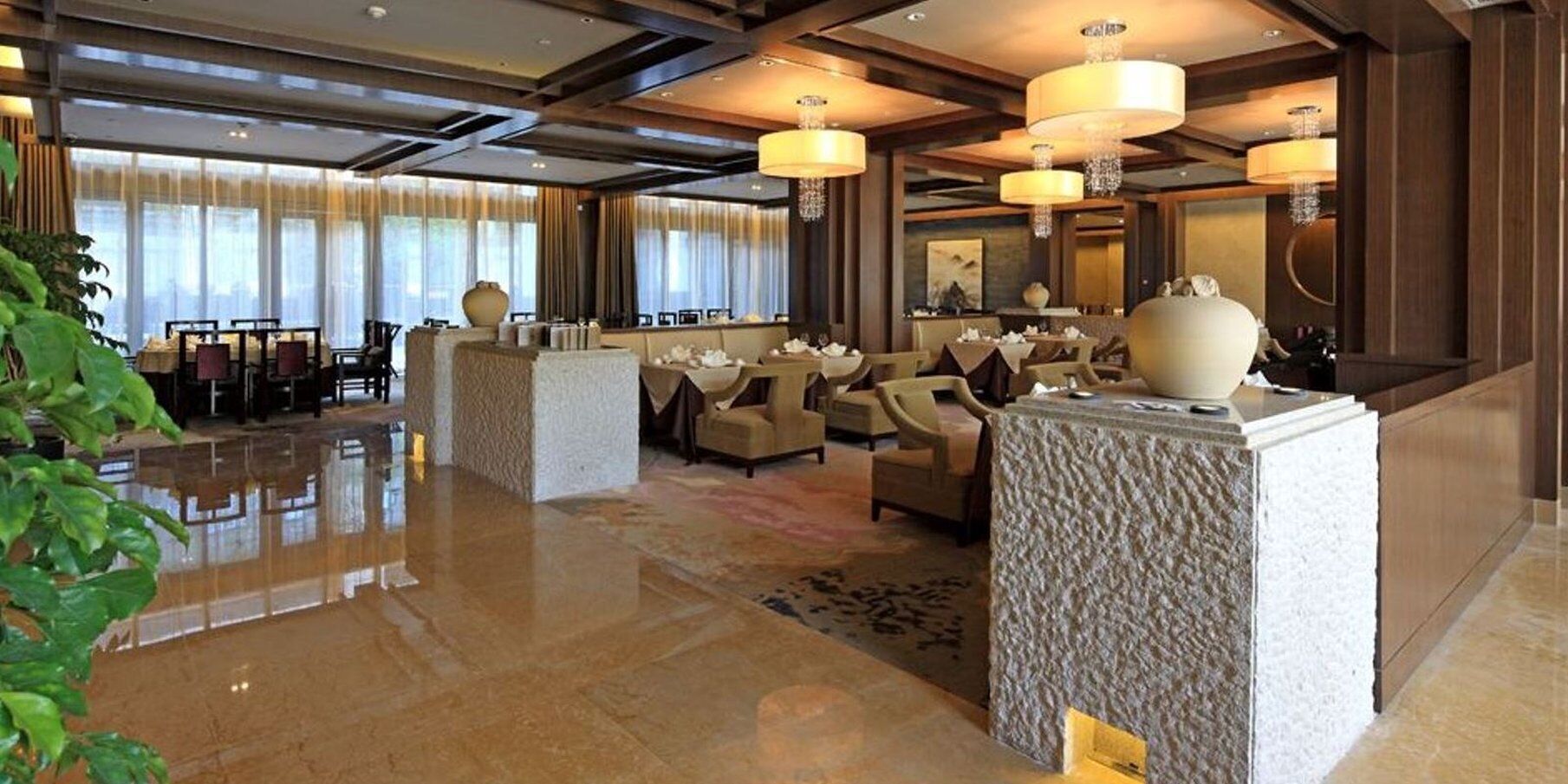 A spacious lobby with a polished floor, seating areas, and a reception desk.