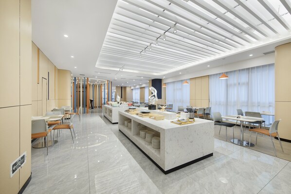A modern hotel lobby with a central reception desk, seating areas, and a large window with curtains. - Holiday Inn Express Chongqing Guanyinqiao by IHG (Chongqing)