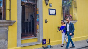 A yellow building with a sign indicating a pet-friendly establishment.