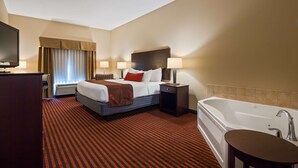 A hotel room with a large bed, a separate bathroom, a desk with a TV, and a window with curtains. - Best Western Plus Louisa (Louisa)