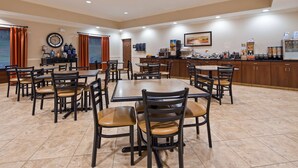 A dining area with multiple tables and chairs, a coffee station, and a buffet with various food items. - Best Western Plus Louisa (Louisa)