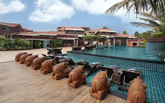 Una piscina al aire libre, sillones reclinables de piscina