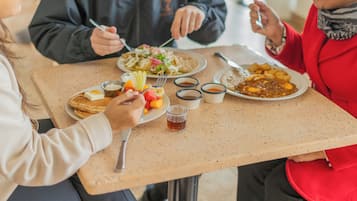 A dining table with food and drinks.