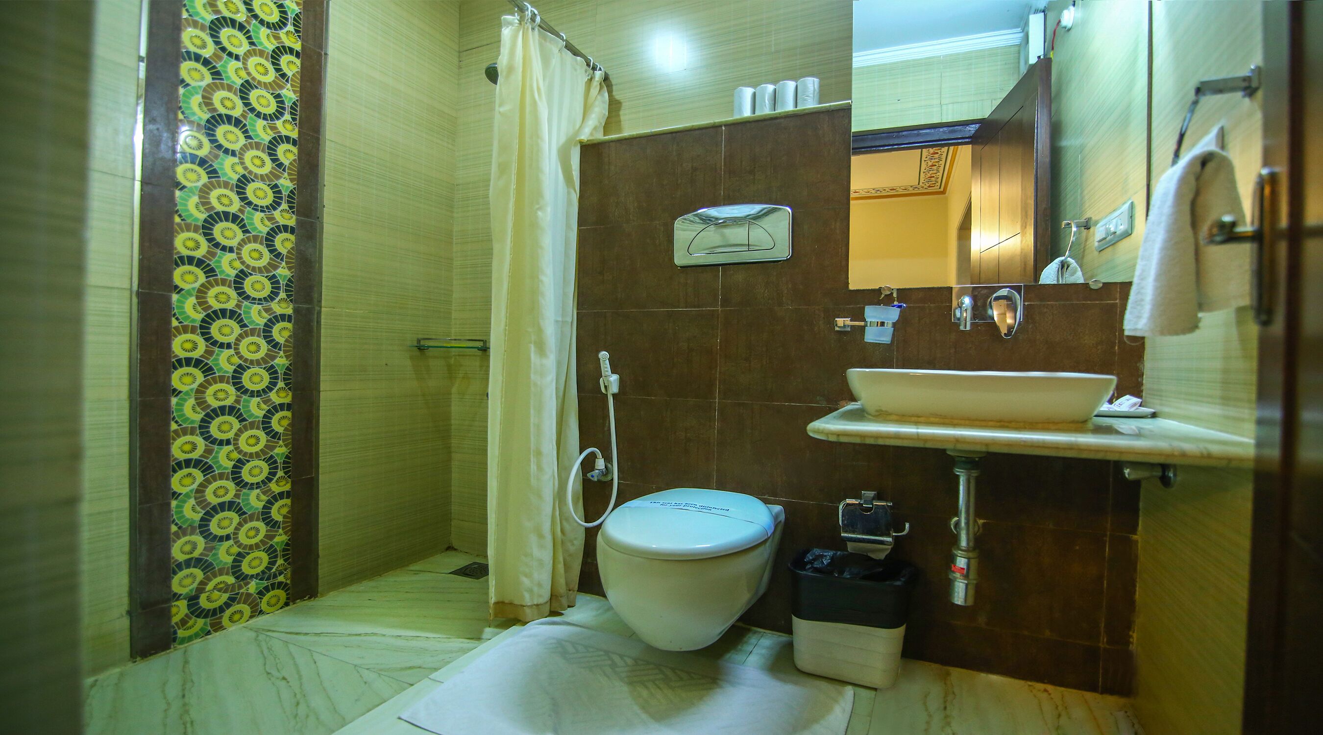 Ein Badezimmer mit Toilette, Waschbecken, Dusche und Spiegel.