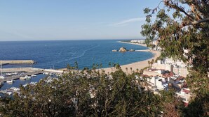 A coastal town with a marina, beach, and residential buildings. - Petit Palau - Adults Only (Blanes)