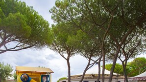 A large elephant sculpture in a grassy area with a playground in the background. - Camping Village Baia Blu La Tortuga (Aglientu)